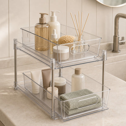 Clear two-tier pull-out organiser storing skincare bottles and towels inside a bathroom vanity