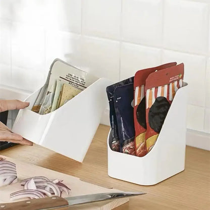Two white compact organiser bins holding packaged ingredients on a kitchen bench