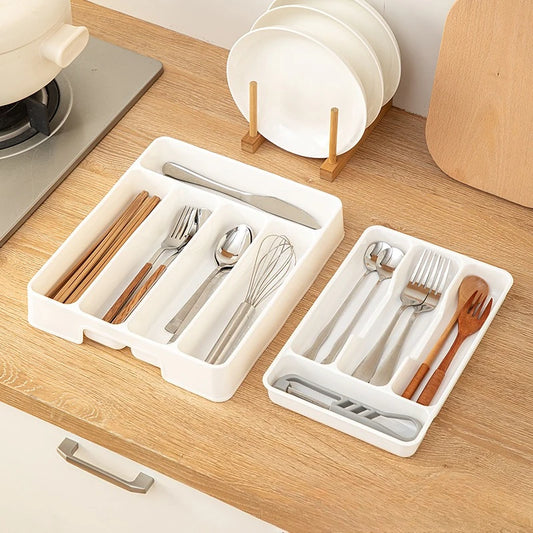 White Ordessa cutlery drawer organisers in compact and large sizes on a timber kitchen bench